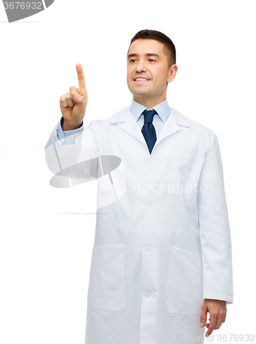 Image of smiling male doctor in white coat pointing finger