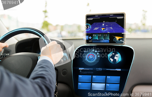 Image of close up of man driving car with navigation system