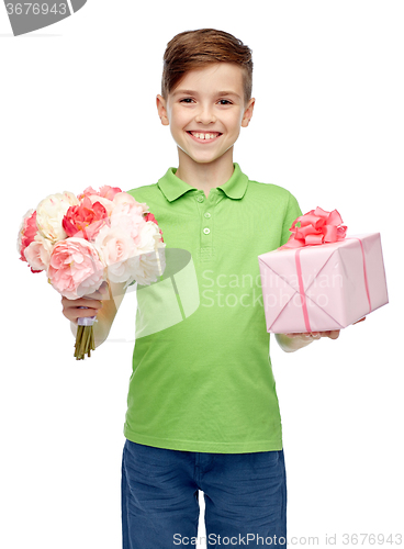 Image of happy boy holding flower bunch and gift box