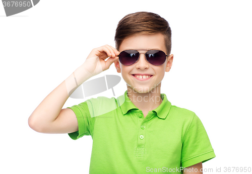 Image of smiling boy in sunglasses and green polo t-shirt