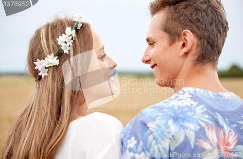 Image of happy smiling young hippie couple outdoors