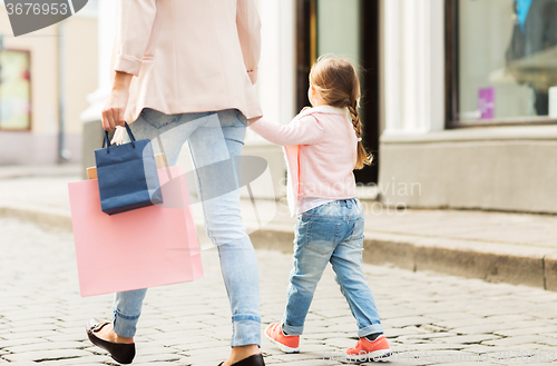 Image of close up of mother and child shopping in city