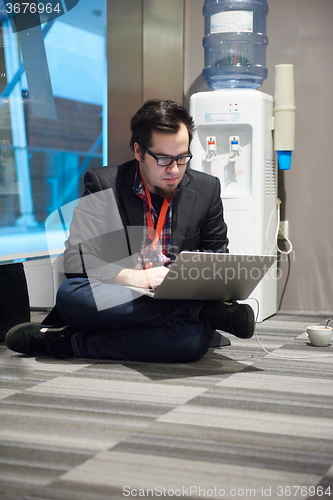 Image of young business man in rush prepare conference presentation on la