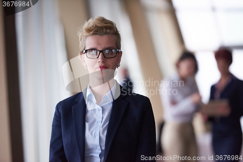 Image of business people group, woman in front  as team leader