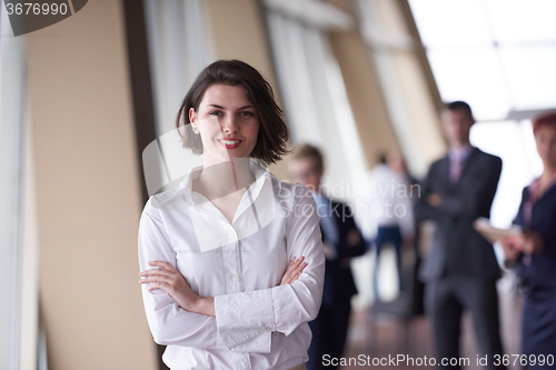 Image of business people group, woman in front  as team leader