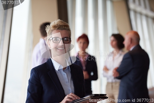 Image of diverse business people group with blonde  woman in front