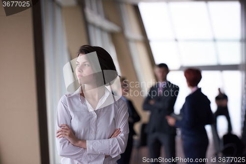 Image of business people group, woman in front  as team leader
