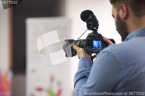 Image of videographer recording on conference