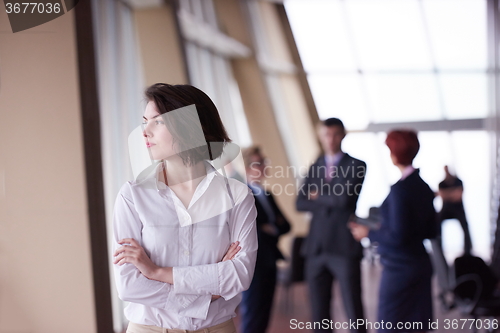 Image of business people group, woman in front  as team leader