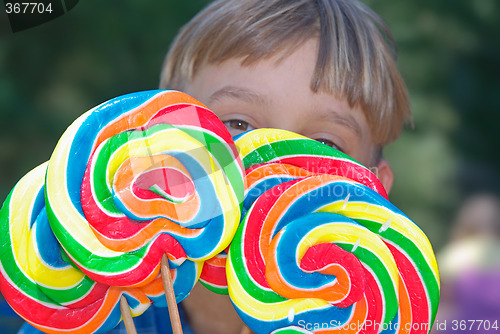 Image of boy with lollipops