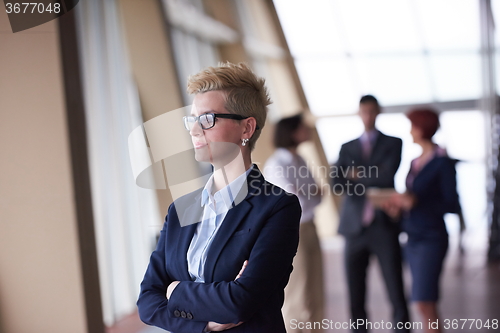 Image of business people group, woman in front  as team leader
