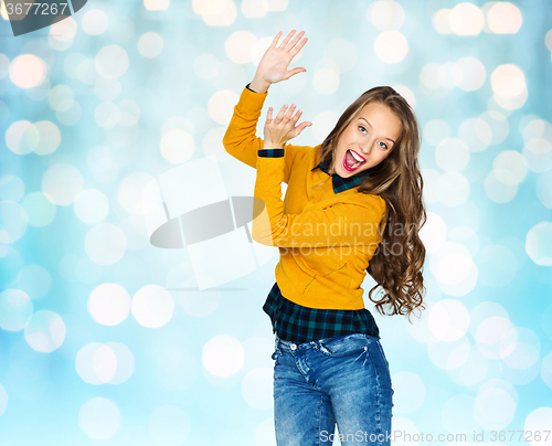 Image of happy young woman or teen girl applauding