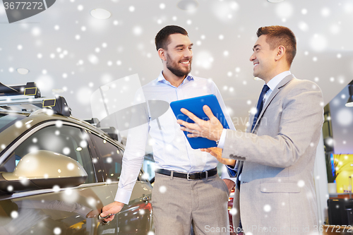 Image of happy man with car dealer in auto show or salon