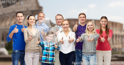 Image of happy people showing thumbs up over coliseum