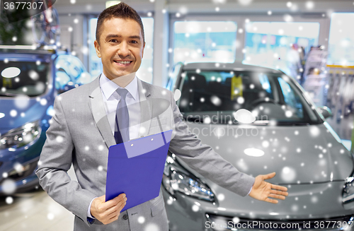 Image of happy man at auto show or car salon
