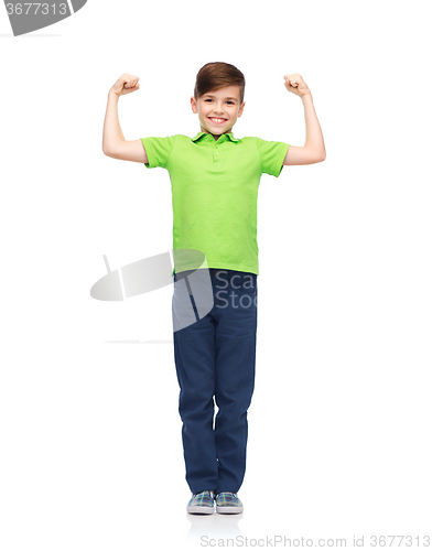 Image of happy boy in polo t-shirt showing strong fists