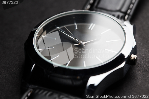 Image of close up of black classic male wristwatch