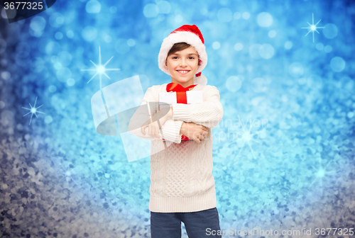 Image of smiling happy boy in santa hat with gift box