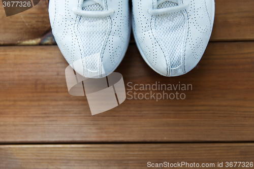 Image of close up of sneakers on wooden floor