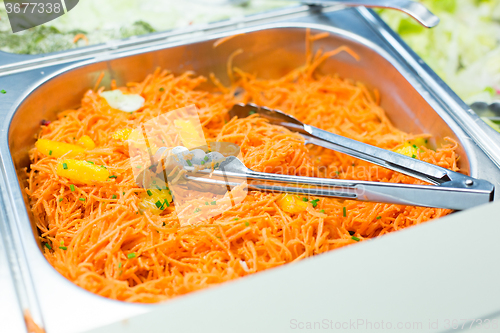 Image of close up of spicy korean carrot salad in container