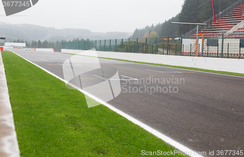 Image of close up of speedway track or road and stands