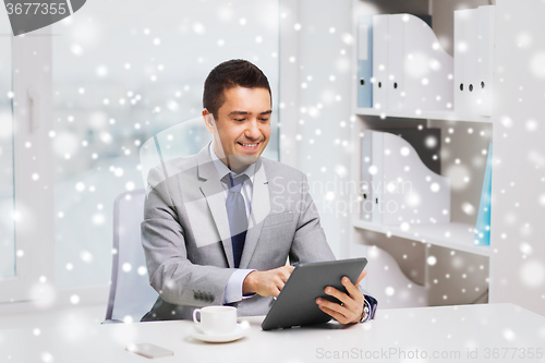Image of smiling businessman with tablet pc and coffee cup