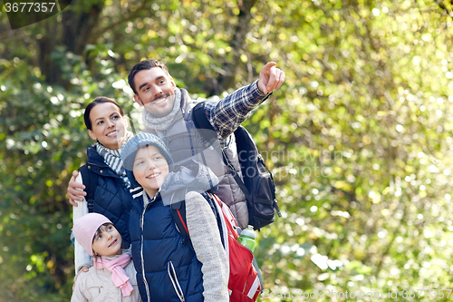 Image of happy family with backpacks hiking