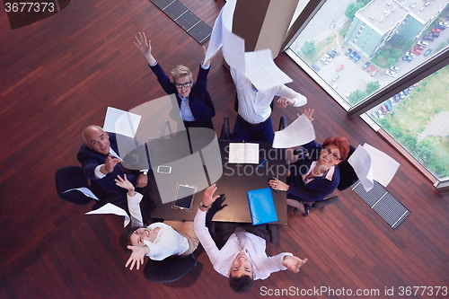 Image of top view of business people group throwing dociments in air