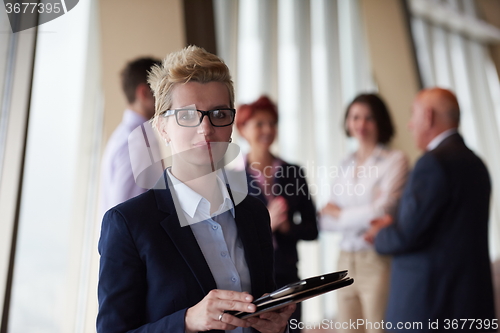 Image of diverse business people group with blonde  woman in front