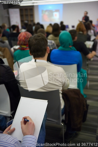 Image of taking notes on business conference