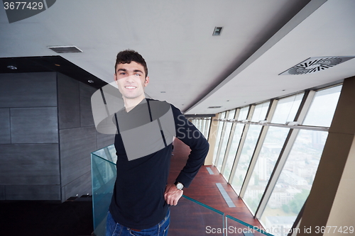 Image of young successful man in penthouse apartment