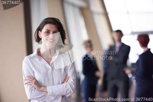 Image of business people group, woman in front  as team leader