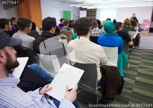 Image of taking notes on business conference