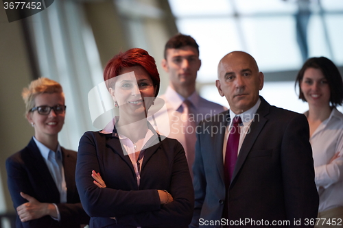 Image of diverse business people group with redhair  woman in front