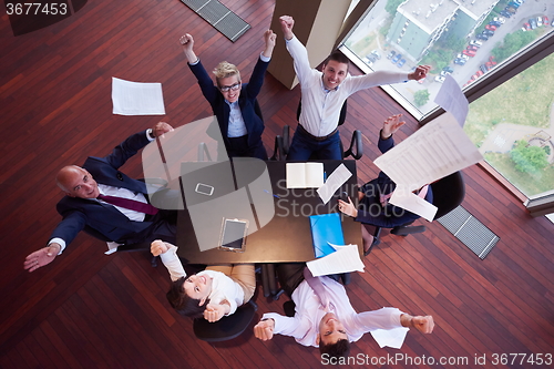 Image of top view of business people group throwing dociments in air