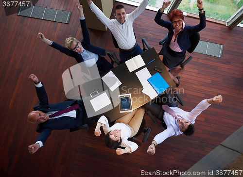 Image of top view of business people group throwing dociments in air