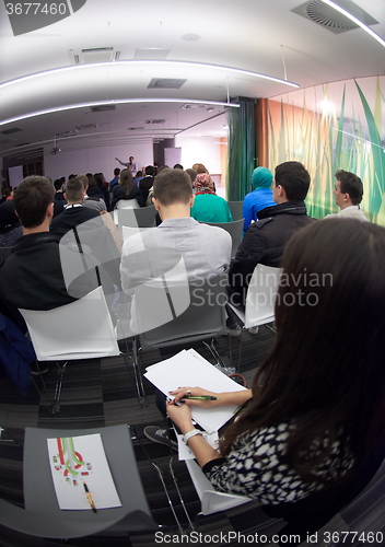 Image of taking notes on business conference