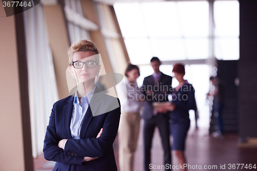 Image of business people group, woman in front  as team leader