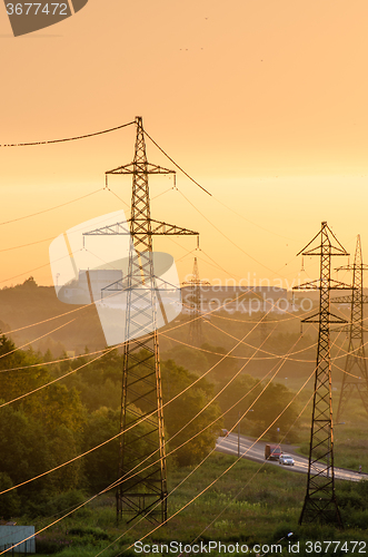 Image of Power lines illuminated by the setting sun