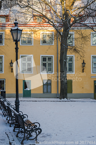 Image of Bench and street lamp in the park winter Old Tallinn