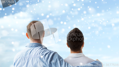 Image of close up of happy male gay couple hugging