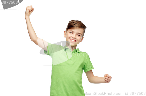 Image of happy boy in polo t-shirt showing strong fists