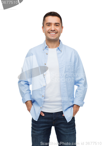 Image of smiling man with hands in pockets