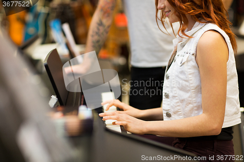 Image of close up of woman playing piano at music store