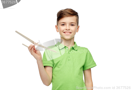 Image of happy boy in green polo t-shirt with toy airplane