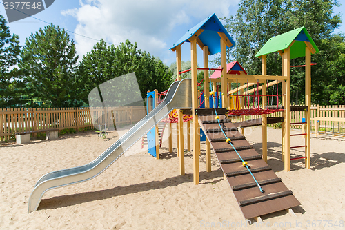 Image of climbing frame with slide on playground at summer
