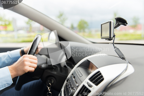 Image of close up of man with gps navigator driving car