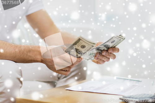 Image of close up of man hands counting money at home