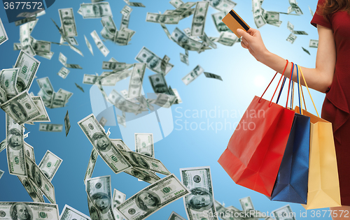 Image of close up of woman with shopping bags and bank card