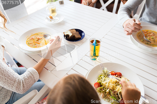 Image of close up of family having dinner at restaurant 